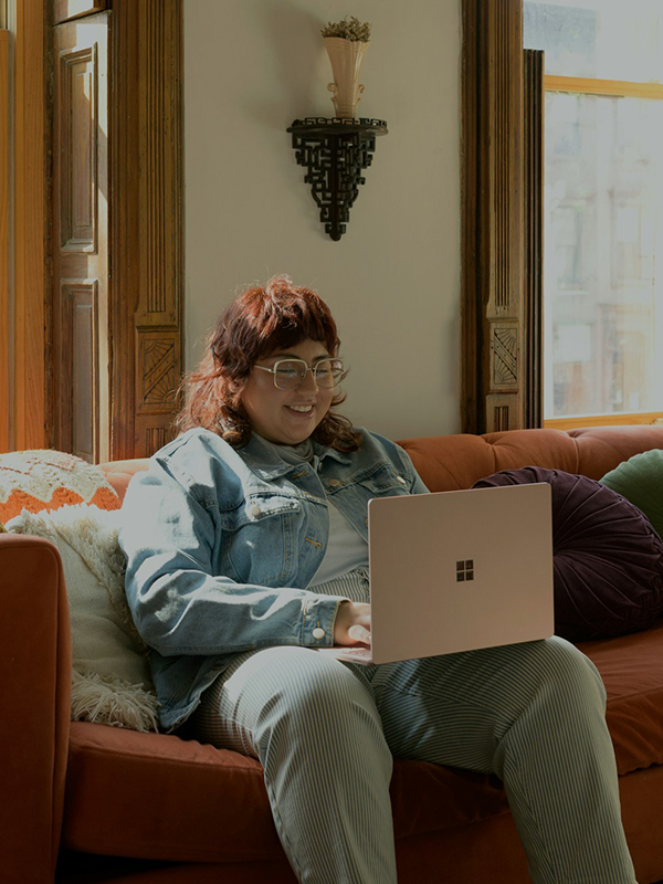 woman at couch on laptop